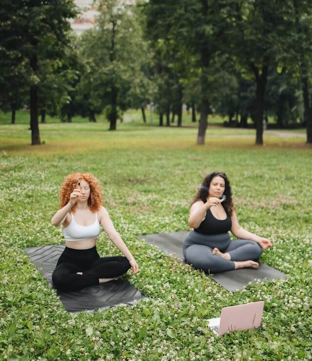 moms doing yoga in the park