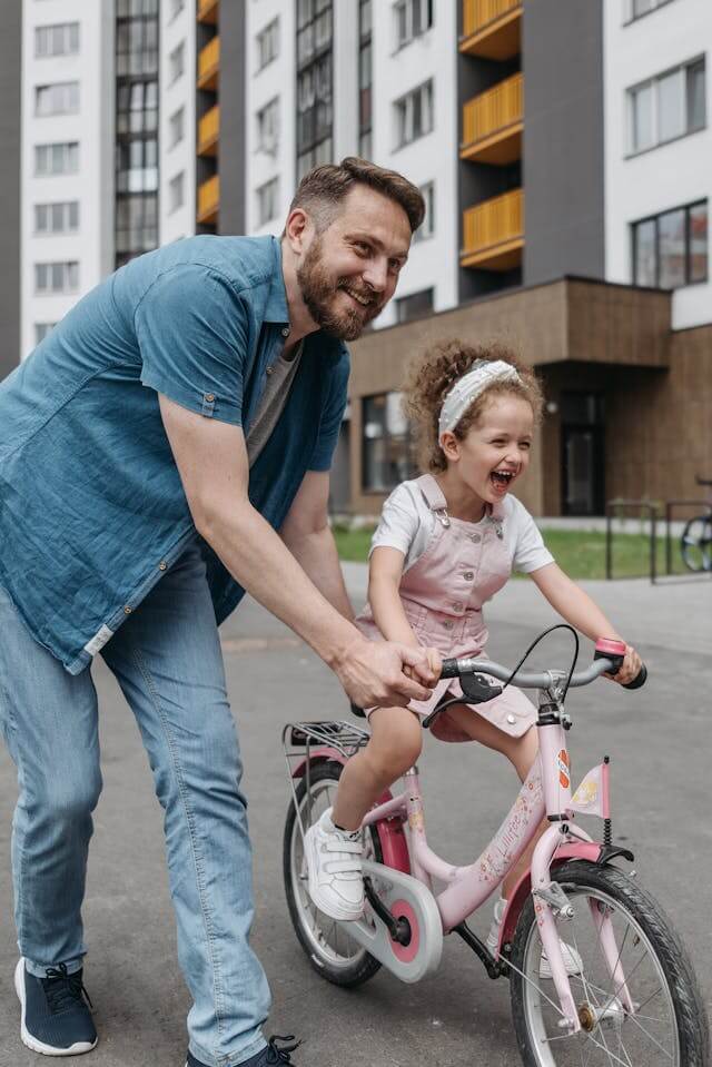 confident child giving effort to try riding a bike