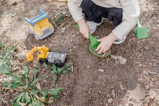 toddler playing in the dirt