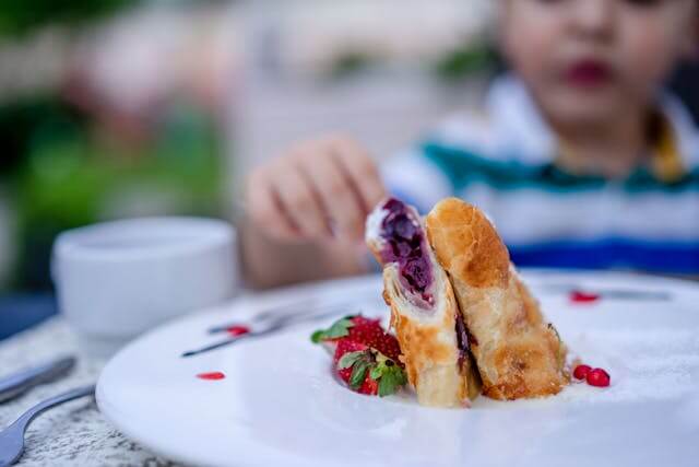 Child in restaurant looking at food