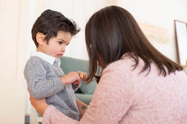 parent consoling grumpy toddler