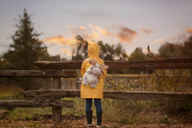 Child in raincoat and backpack