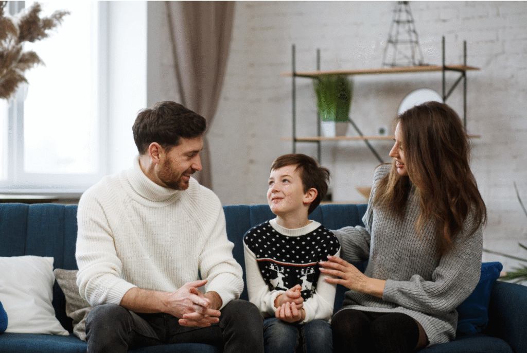 coparenting parents and child on a couch