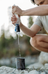 man squeezing water through filter