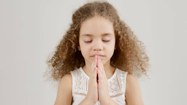 girl with gratitude namaste hands prayer