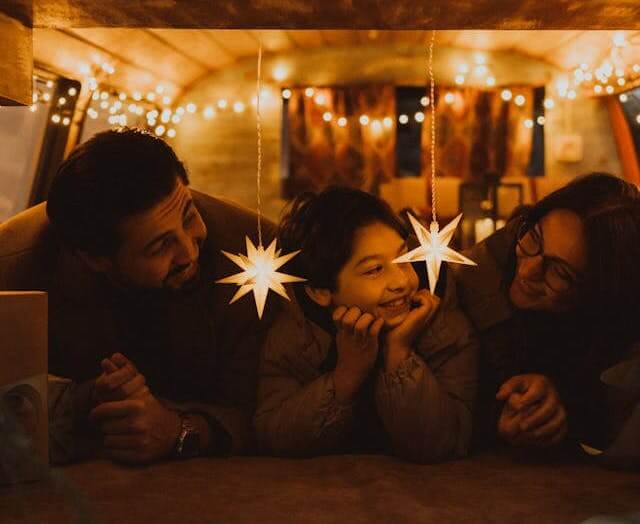happy sober family celebrating under festive lights