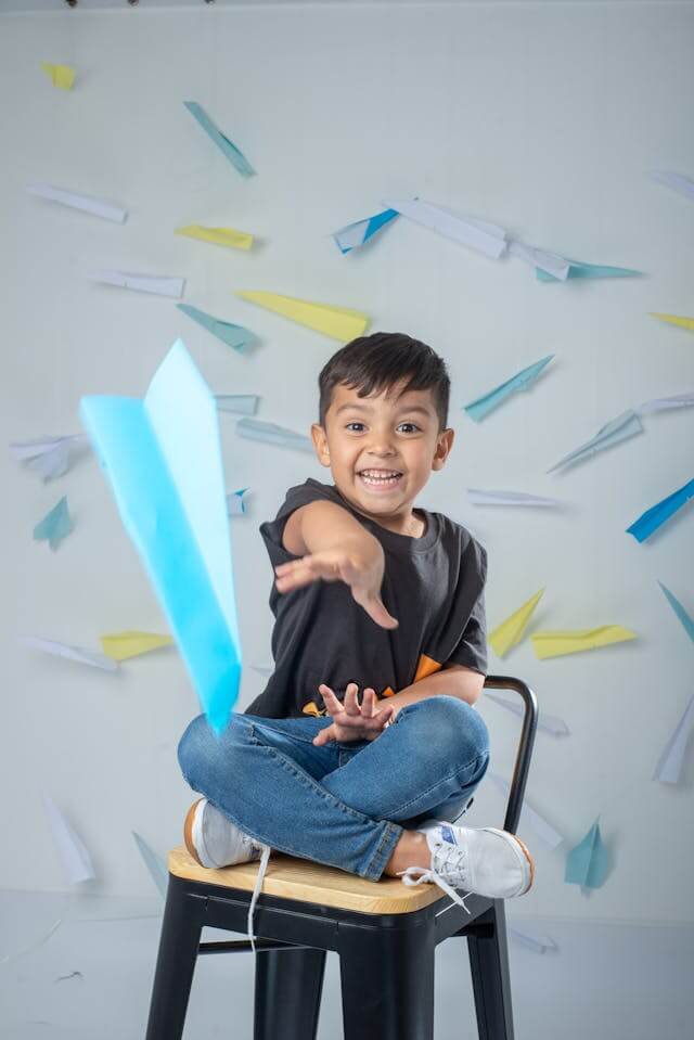 boy with paper planes