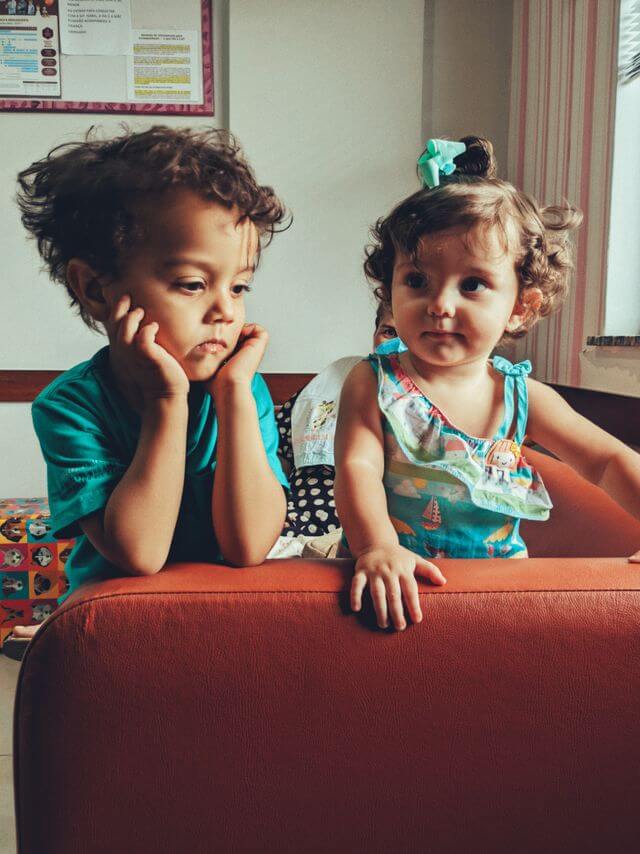 two toddlers on a couch