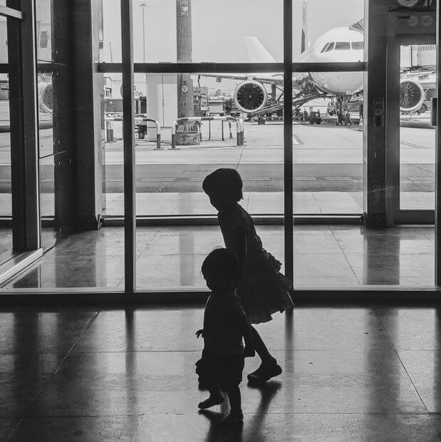 Children in an airport traveling internationally