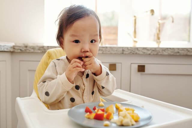 baby eating first foods
